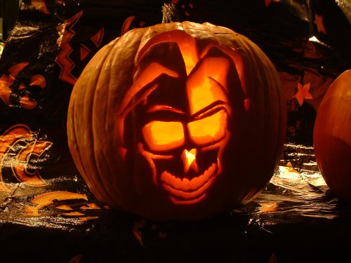 Jack-o-Lantern with a jester face carved out of it.